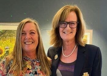 Judith Rose (left) receives a prize for her ace from Bramhall lady captain Jo Lingwood.