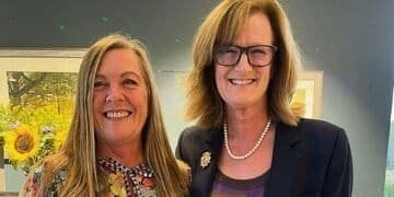 Judith Rose (left) receives a prize for her ace from Bramhall lady captain Jo Lingwood.