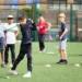England Golf Partners with Mind to Support Mental Wellbeing Young golfers practicing their skills while receiving guidance from a coach.