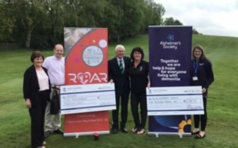 Macclesfield Golf Club Captains Donate £10,000 to Charity A group of people standing in front of a large cheque.