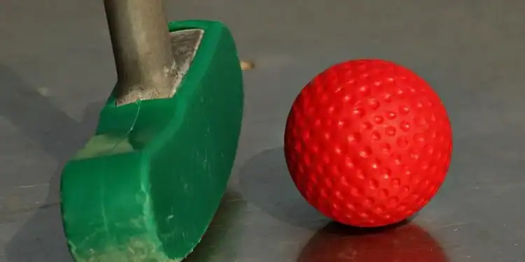 Junior Journey Partnership To Inspire Young Golfers a green and red golf club and a red ball