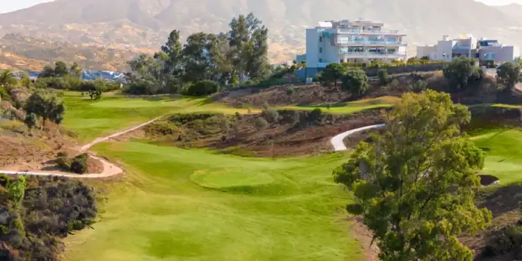 La Cala Resort Expands Golf Experience with New Short Course a golf course with a building in the background