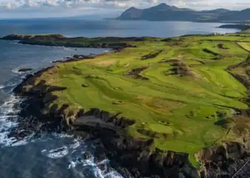 Nefyn Golf Club Society Golf Day Deals View of golfers on Nefyn Golf Club’s dramatic peninsula with the Irish Sea beyond.