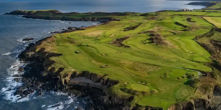Nefyn Golf Club Society Golf Day Deals View of golfers on Nefyn Golf Club’s dramatic peninsula with the Irish Sea beyond.
