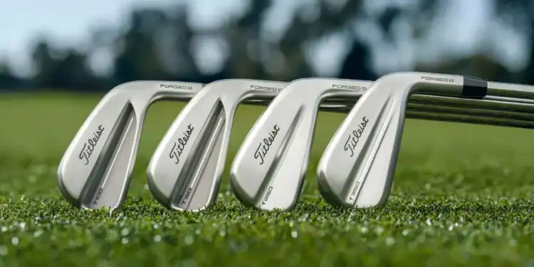 Titleist Unveils Next Generation T-Series Irons for 2025 a group of golf clubs on grass