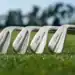 Titleist Unveils Next Generation T-Series Irons for 2025 a group of golf clubs on grass
