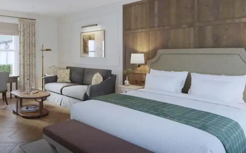 Dunluce Lodge: Five-Star Luxury on the Edge of Royal Portrush A room with a bed and a couch.