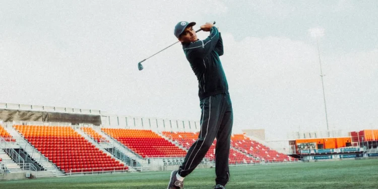 PUMA Golf & Reigning Champ: Field to Fairway Collaboration Rickie Fowler swinging a golf club.