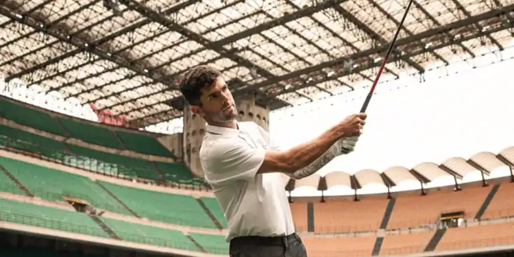 PUMA Golf: Redefining Sports Performance Apparel Christian Pulisic holding a golf club in a stadium.