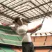 PUMA Golf: Redefining Sports Performance Apparel Christian Pulisic holding a golf club in a stadium.