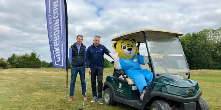 Recycling UK Ltd Sponsor Hope House Charity Golf Day a man standing next to a person in a golf cart
