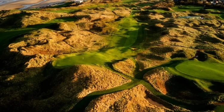 Gareth Bradley Wins Seniors Frank Stableford Trophy a golf course with sand dunes and water in the background
