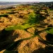 Gareth Bradley Wins Seniors Frank Stableford Trophy a golf course with sand dunes and water in the background