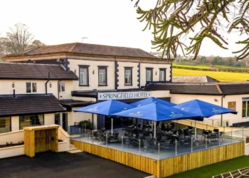 Gateway to Wales Spring Golf Festival 2025 a building with a patio and umbrellas