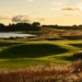 Tom Doak’s Old Petty Course Set for Summer Debut at Cabot Highlands a golf course with a lake and trees