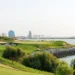 Viya Golf GEO Certification for Yas Links and Yas Acres a golf course with water and city in the background