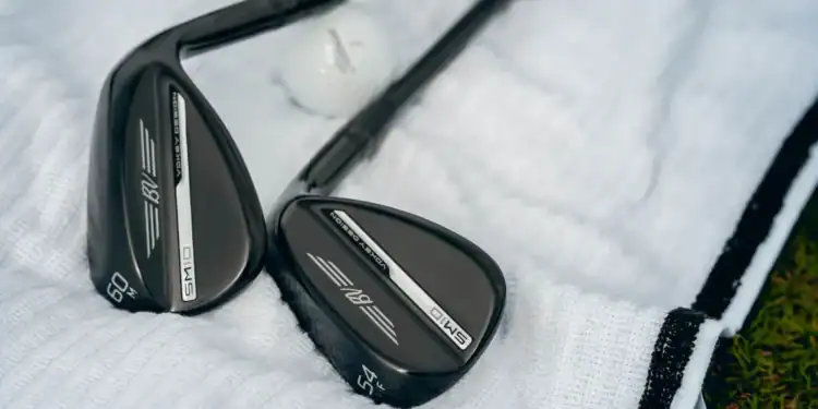 Titleist Reveals Vokey SM10 Black Vapor Wedges for 2025 Close-up of Titleist Vokey SM10 Black Vapor wedges with black finish, resting on a white golf towel.