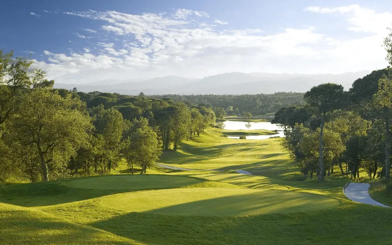 Camiral to Host 2031 Ryder Cup in Spain a golf course with trees and water