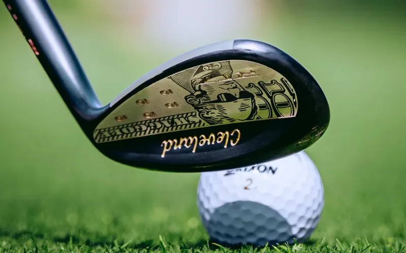 Limited-Edition SWAG RTZ Wedge from Cleveland Golf Golf club poised over a ball.
