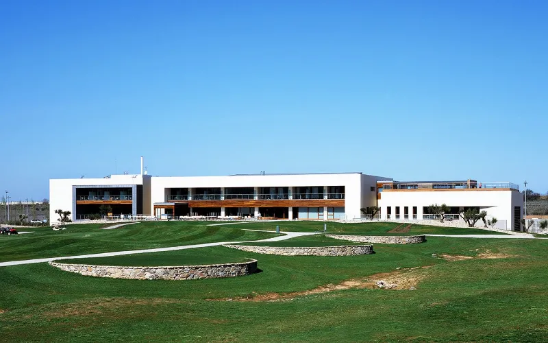 Discover Madrid’s World-Class Golf Venues a building with a lawn and grass