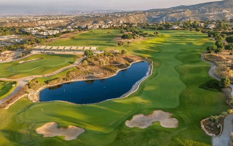 Aphrodite Hills Launches Major Investment Plan a golf course with a lake