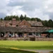 Prestbury’s Joan Crouch Wins Wild Cup at 90 Years Old a building with people sitting on the porch