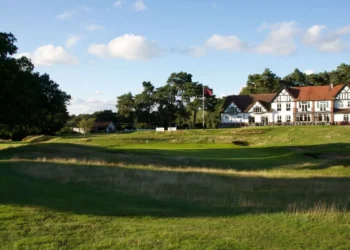 Cheshire Senior Ladies Championship 2025 a golf course with a building and a flag on the side