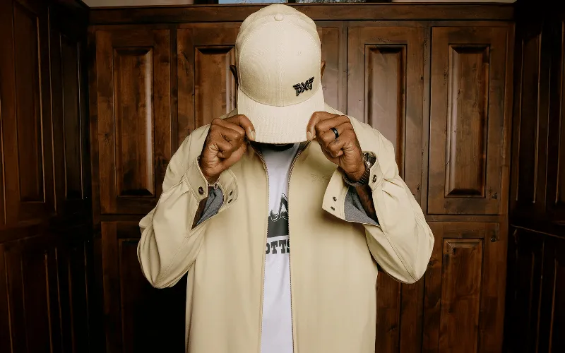 PXG Launches Fall Winter 2025 Apparel Collection Man wearing stylish beige jacket and cap