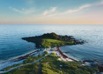 Lofoten Links Northern Lights Above the Arctic Circle Golf course surrounded by serene waters.