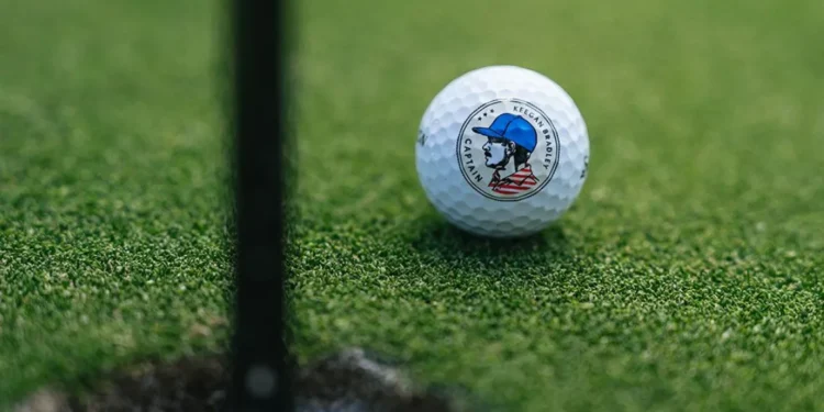 Srixon Celebrates U.S. Captaincy with Keegan Bradley Signature Series Golf ball near hole on green.