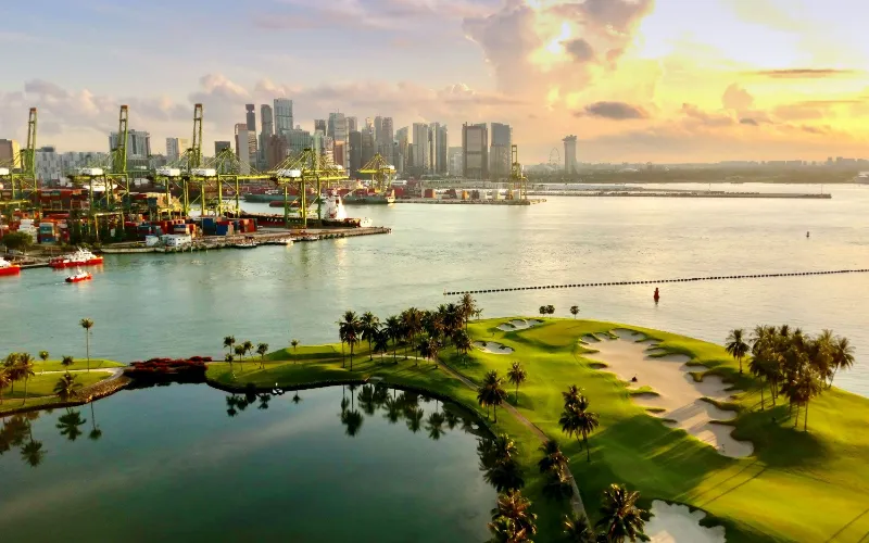 Sentosa Golf Club Launches Grass Trackman Range Stunning golf course with city skyline backdrop.
