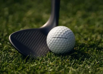 Titleist Pro V1 Left Dot Golf Ball Returns Golf ball and club on grass.