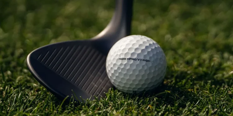 Titleist Pro V1 Left Dot Golf Ball Returns Golf ball and club on grass.