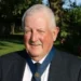 Manchester Alliance Launches 2025 Winter Golf Season Man in suit at golf club event.