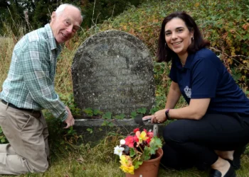 Ashton-on-Mersey Golfers Honour Ryder Family Legacy Two people tending to a gravestone.
