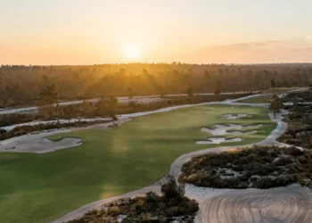 Sergio García Unveils The Torre Course at Terras da Comporta Sunset over a lush golf course.