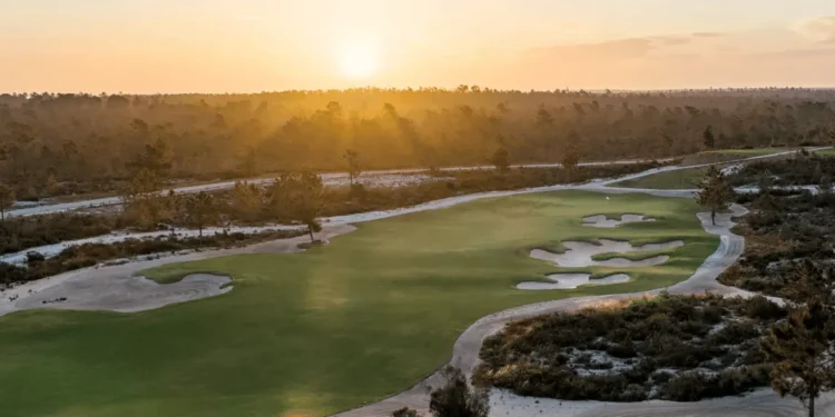 Sergio García Unveils The Torre Course at Terras da Comporta Sunset over a lush golf course.