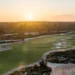 Sunset over a lush golf course.