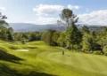 Terre Blanche Partners with Troon Golf in France Lush golf course under blue skies.