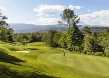 Terre Blanche Partners with Troon Golf in France Lush golf course under blue skies.