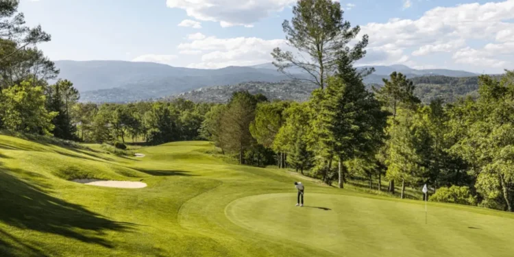 Terre Blanche Partners with Troon Golf in France Lush golf course under blue skies.