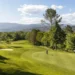 Terre Blanche Partners with Troon Golf in France Lush golf course under blue skies.