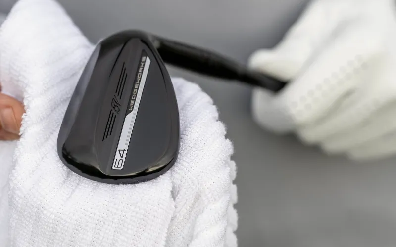Vokey WedgeWorks 64 T Grind lob wedge with Black Vapor finish against a white background.