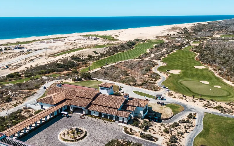 Solmar Golf Links ranchero-style clubhouse perched above ocean with putting green.