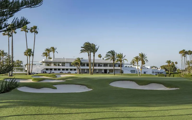 Luxurious golf resort with palm trees.