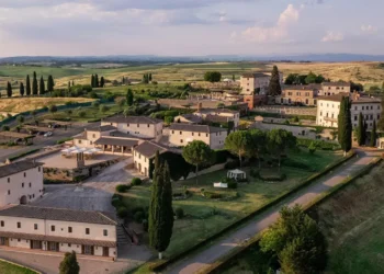 La Bagnaia Golf Resort aerial view showing Tuscan estate buildings and golf course landscape near Siena.