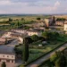 La Bagnaia Golf Resort aerial view showing Tuscan estate buildings and golf course landscape near Siena.