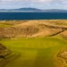 The revetted bunkers and towering dunes of The Machrie golf course on the Isle of Islay, Scotland.